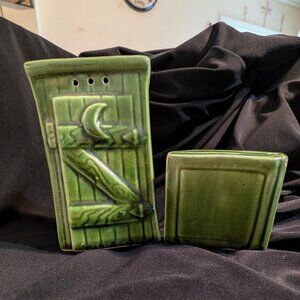 Green ceramic novelty salt and pepper shakers in outhouse and catalogue design